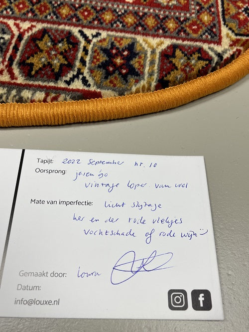 Vintage tapijt donkerblauw/rood/crème/geel van kleur